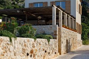 a stone wall in front of a house at Villa Vito in Hvar