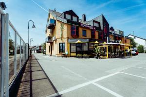 a building on a street next to a parking lot at Design Hotel Euskirchen in Euskirchen
