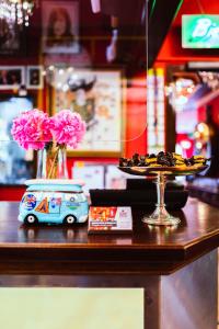 a table with a vase of flowers and a toy car at Design Hotel Euskirchen in Euskirchen