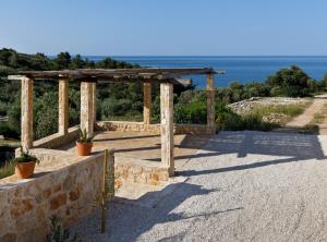a wooden pergola with a view of the ocean at Villa Vito in Hvar