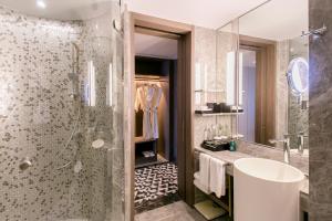 a bathroom with a shower and a sink at Centara Grand At CentralWorld in Bangkok