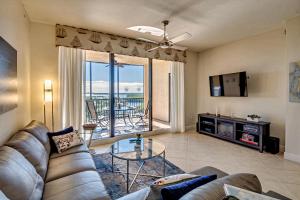 a living room with a couch and a table at Vista Del Mar at Cape Harbour Marina, 10th Floor Luxury Condo, King Bed, Views! in Cape Coral