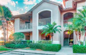 a house with palm trees in front of it at 5 Room at PgaVillageResort by AmericanVacationliving in Port Saint Lucie