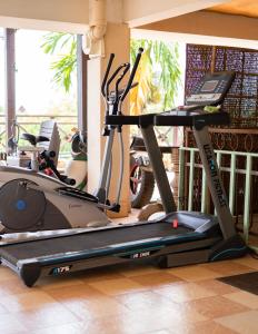 a gym with a treadmill in a room with a window at Siem Reap Riverside Hotel in Siem Reap