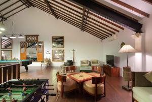 a living room with a table and a pool table at South Lake Resort Koggala in Koggala