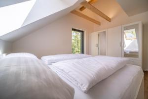 a bedroom with two white beds and a window at Holiday House U Hájenky 12P Lipno Home in Lipno nad Vltavou