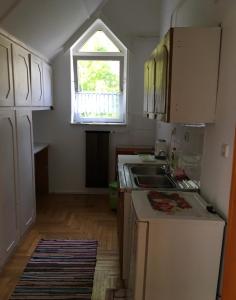a kitchen with a sink and a window at Eva Rooms in Budakeszi +14 photos