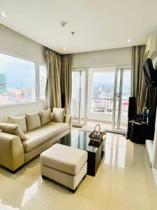 a living room with a couch and a table at D&C Hotel in Da Nang