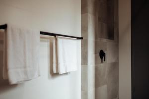 a bathroom with a shower curtain and a window at Jaspers Cabins in Pemberton