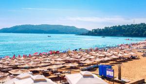 a beach with a lot of umbrellas and the water at Sunny Side apartment in Bečići