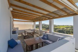 a view from the balcony of a house with a table and chairs at Casa Mia Milos in Paleochori
