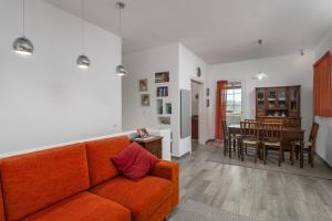 a living room with a couch and a dining room at Casa Mia Milos in Paleochori