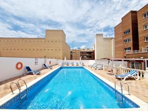 a swimming pool on the roof of a building at Hotel Santa Cecilia in Ciudad Real