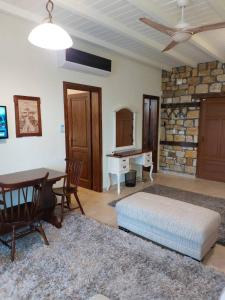 a bedroom with a bed and a table and a desk at The Stone Heaven in Galíni