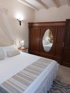 a bedroom with a large bed with a large mirror at The Stone Heaven in Galíni
