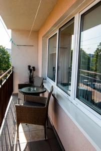 a balcony with a table and chairs and windows at Apartament Cztery Pory Roku w Giżycku in Giżycko