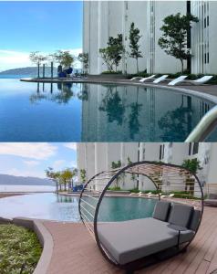 a pool with a chair in front of a building at Cozy Ocean View APT in KK City Center in Kota Kinabalu