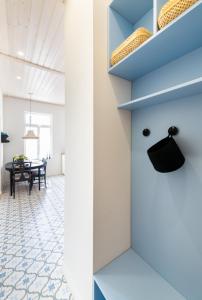 a dining room with a table and blue shelves at Haapsalu OldTown apartment in Haapsalu