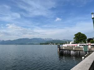 a boat docked at a dock on a lake at Altstadtjuwel in Gmunden am Traunsee in Gmunden