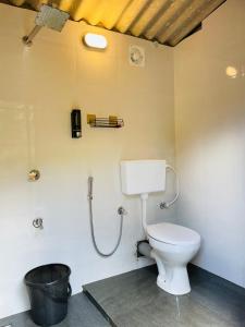 a bathroom with a toilet and a shower at TENT LIFE in Vagamon