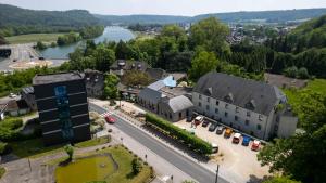 an aerial view of a town with a river and buildings at Hotel Les Jardins De La Molignée in Dinant