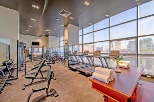 a gym with rows of treadmills and exercise bikes at Poulo Wai Hotel & Apartment in Phnom Penh