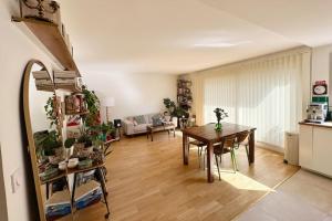 a living room with a table and a dining room at Cosy, calm 70m2, 2 bedroom flat. in Paris
