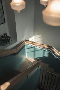 a swimming pool with a glass floor and stairs at Parkhotel Holzner in Soprabolzano