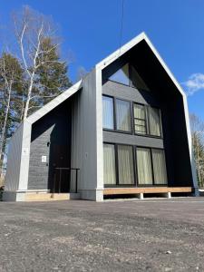 a large black and white building with a door at Niseko White Villas YUNOSATO in Rankoshi