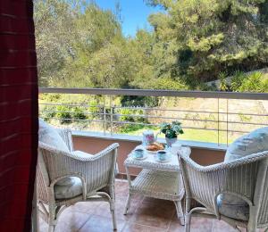 a table and chairs on a balcony with a view at Villa Julia in Sani Beach