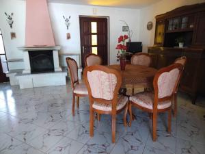a dining room with a table and chairs and a fireplace at Spacious Holiday Home in Verteneglio in Brtonigla