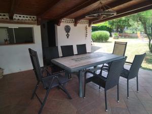 a wooden table and chairs on a patio at Spacious Holiday Home in Verteneglio in Brtonigla