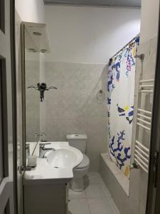 a bathroom with a sink and a toilet at Apartment On Botanikuri 17 in Tbilisi City