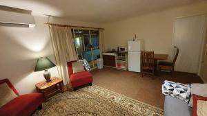 a living room with a couch and a table at Oaktree Guest House in Narbethong