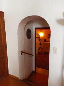 a hallway with an archway leading into a room at Apartment in the heart of Cotignac in Cotignac