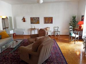 a living room with a couch and a chair at Apartment in the heart of Cotignac in Cotignac