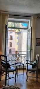 a room with a large window with a view of a building at Apartment in the heart of Cotignac in Cotignac