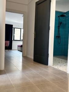 a bathroom with a shower and a black door at Peaceful condo for romantic getaways near Black Church - 3min walk in Braşov