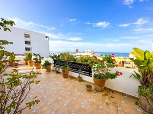 a balcony with potted plants and a view of the ocean at Diamond of Mekkade, Sea view with swimming pool in Oued Laou