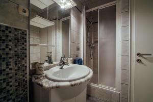 a bathroom with a sink and a shower at Guesthouse Villa Diana in Makarska