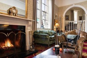 a living room with a couch and a fireplace at Ballina Manor Hotel in Ballina