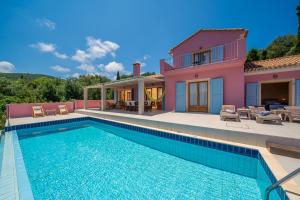 a villa with a swimming pool and a house at Villa Helios Sea View & Private Pool near Fiskardo in Fiskardo