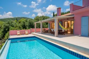 a villa with a swimming pool and a house at Villa Helios Sea View & Private Pool near Fiskardo in Fiskardo