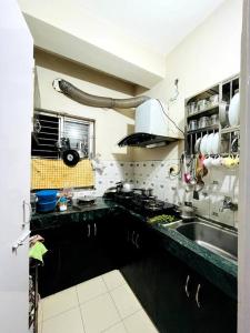 a kitchen with a sink and a counter top at Kaveri home stays in Guwahati +8 photos