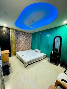a bedroom with a bed and a blue ceiling at Kaveri home stays in Guwahati