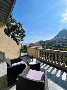 a patio with two chairs and a table with a view at Casa Tutti Frutti in Positano