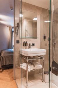 a bathroom with a sink and a shower at H5 Grauer Bär Studios & More in Innsbruck