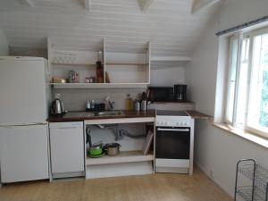 a kitchen with white appliances and a white refrigerator at Helsinki Blue House in Helsinki