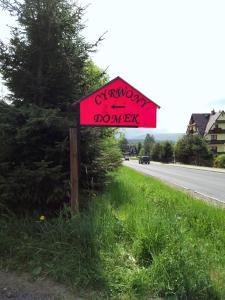 a red sign on the side of a road at Cyrwony Domek in Poronin