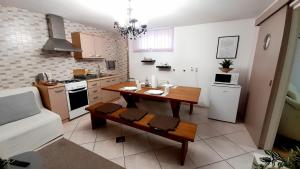 a kitchen with a wooden table and a dining room at Apartment Eleco in Bjelovar